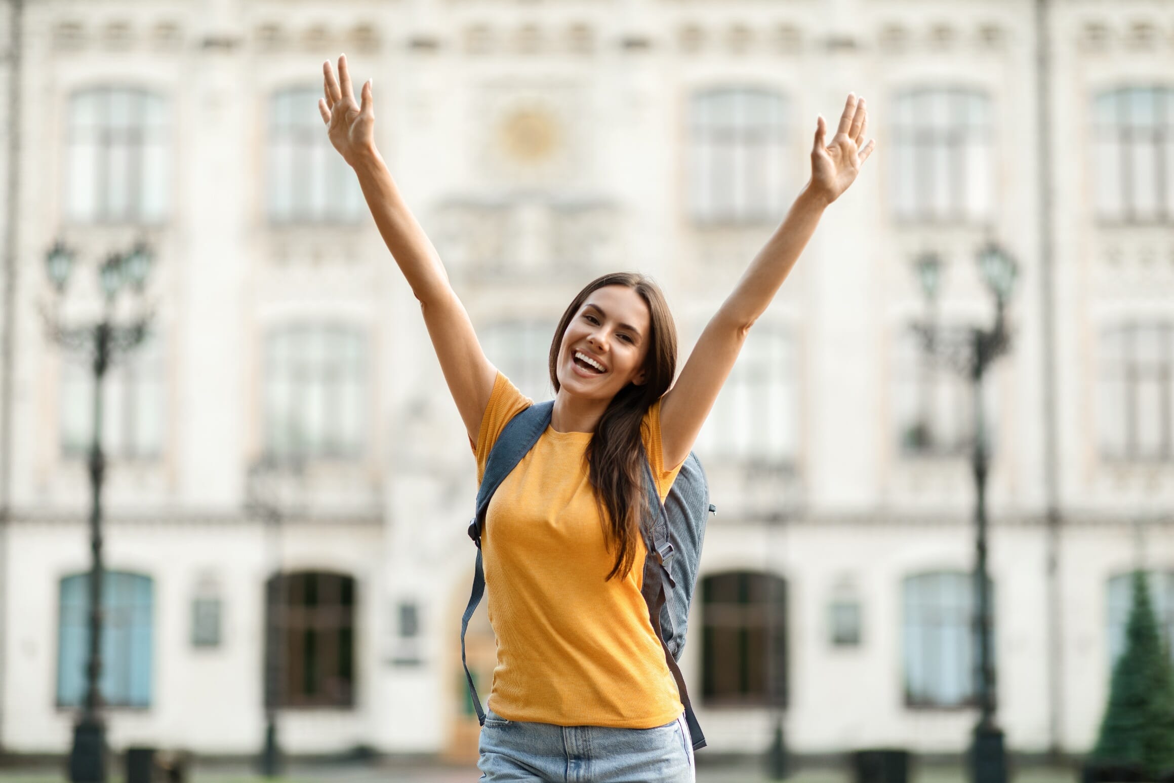 joyful-college-female-raising-arms-and-celebrating